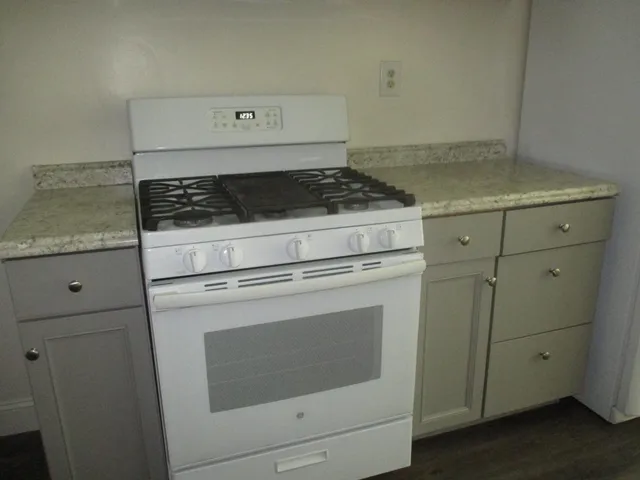 a stove top oven sitting inside of a kitchen