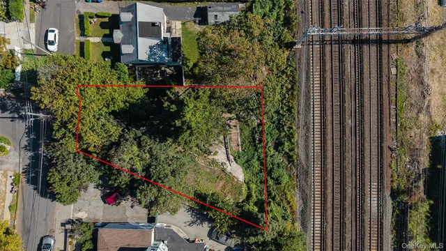 an aerial view of residential house with outdoor space and trees