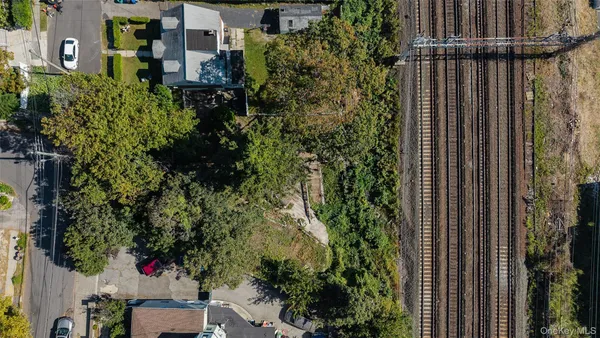 an aerial view of residential house with outdoor space and trees