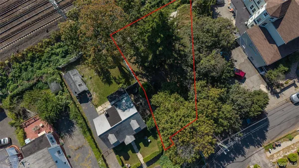 an aerial view of a house with garden space and street view