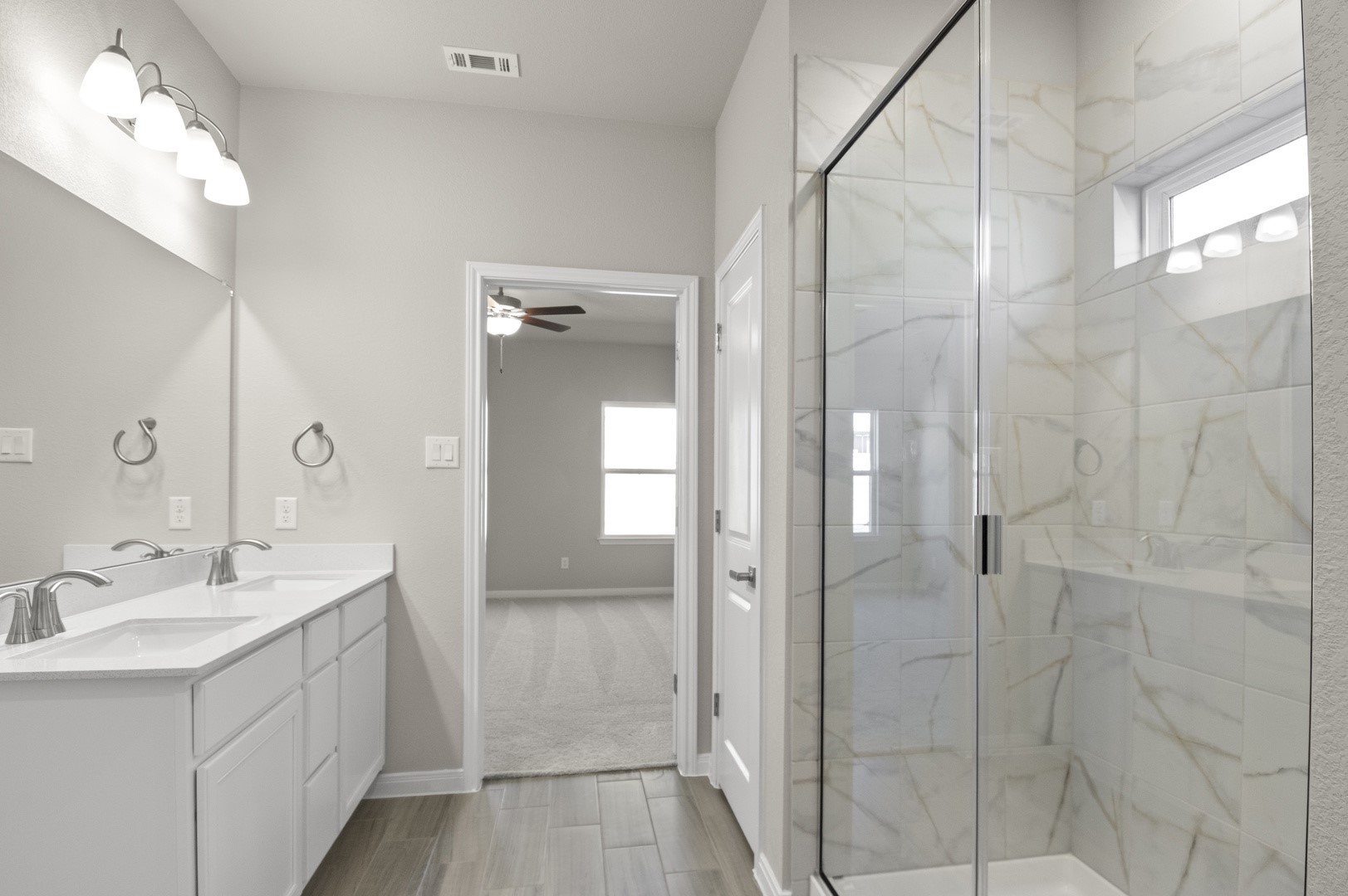 108 Outlaw Drive Jarrell, TX 76537 - Photo 12 of 17 a bathroom with a double vanity sink mirror and shower