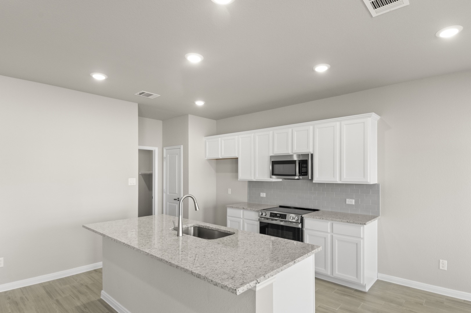 108 Outlaw Drive Jarrell, TX 76537 - Photo 4 of 17 a kitchen with stainless steel appliances granite countertop a sink a stove and a refrigerator