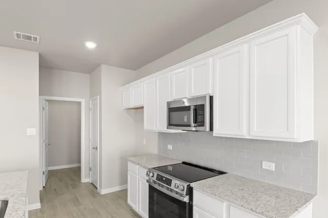 a view of kitchen with sink microwave and refrigerator