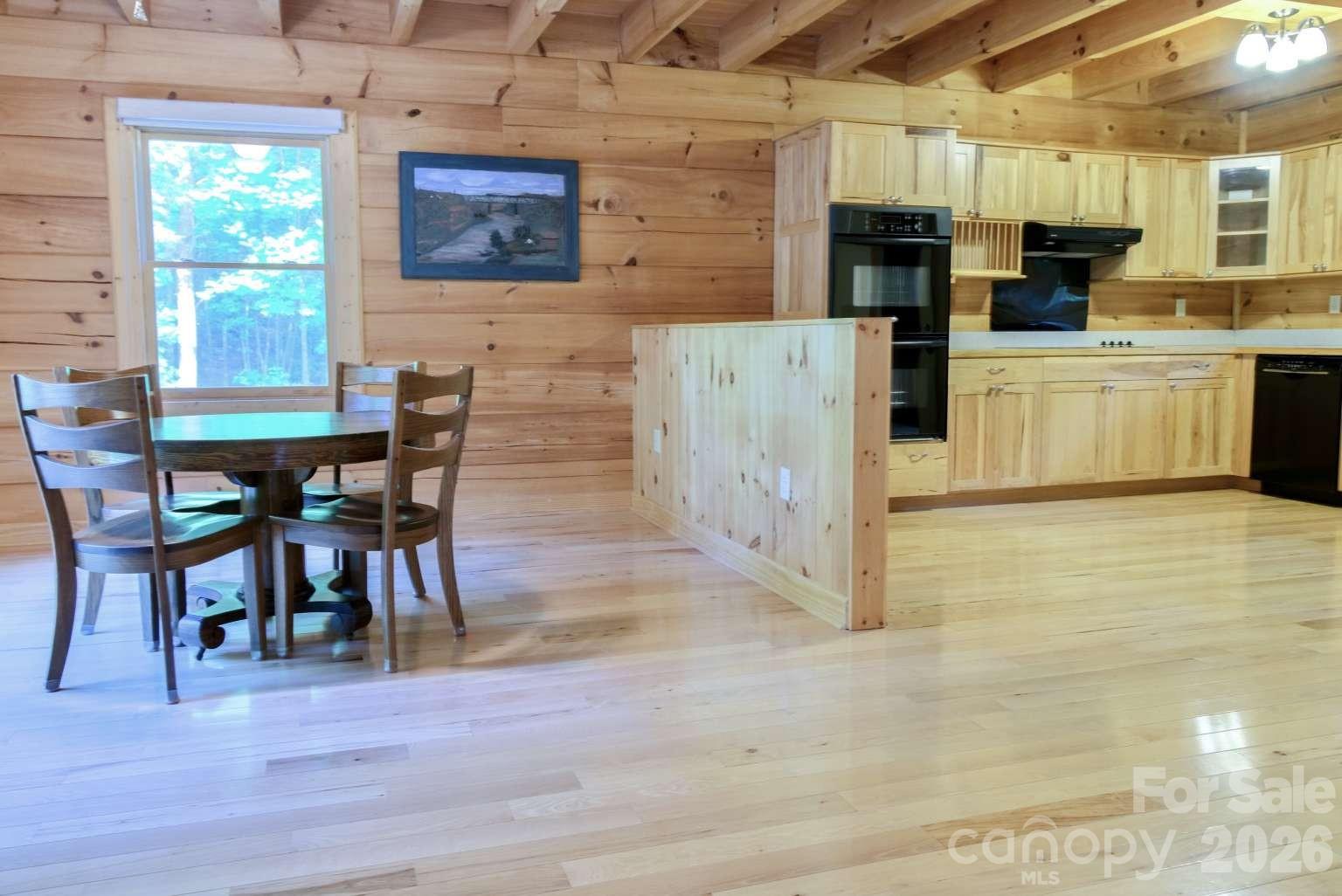 3815 Bat Cave Road Old Fort, NC 28762 - Photo 14 of 45 a view of kitchen with stainless steel appliances wooden floor dining table and chairs
