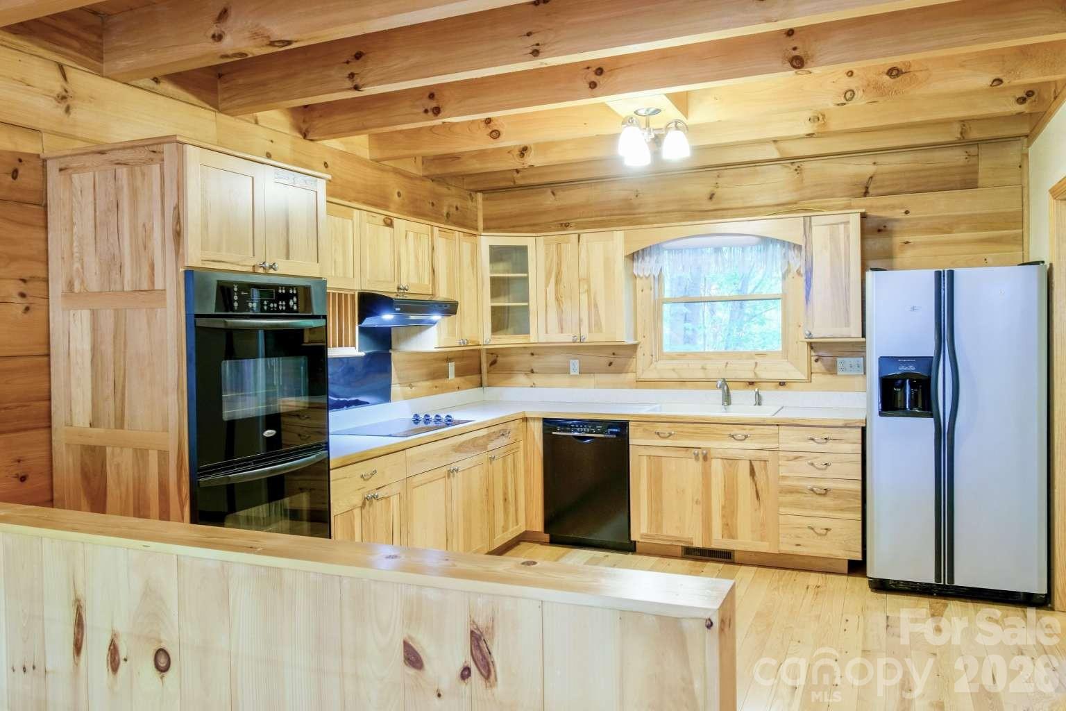 3815 Bat Cave Road Old Fort, NC 28762 - Photo 15 of 45 a kitchen with stainless steel appliances granite countertop a refrigerator and a stove top oven