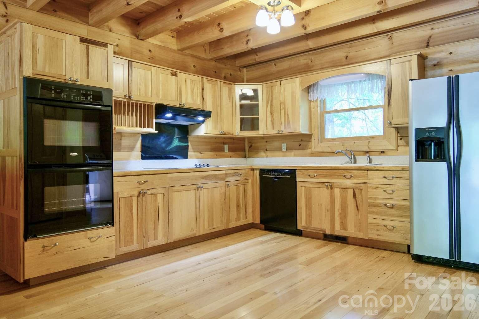 3815 Bat Cave Road Old Fort, NC 28762 - Photo 16 of 45 a kitchen with stainless steel appliances a stove sink and refrigerator