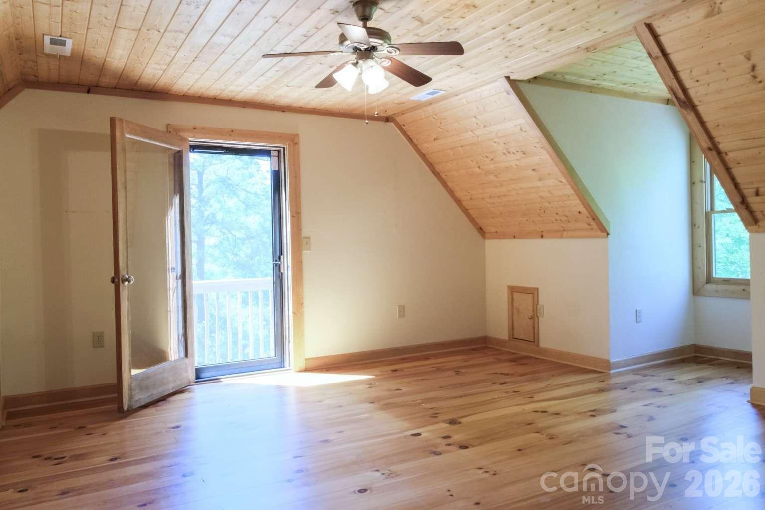 3815 Bat Cave Road Old Fort, NC 28762 - Photo 24 of 45 a view of an empty room with wooden floor and windows