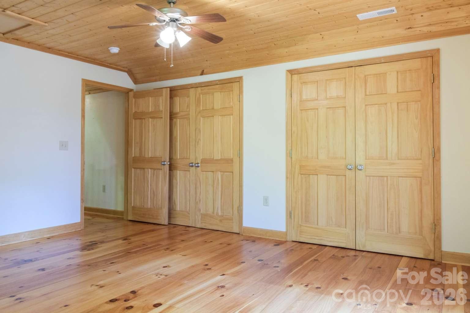 3815 Bat Cave Road Old Fort, NC 28762 - Photo 25 of 45 an empty room with wooden floor closet and windows