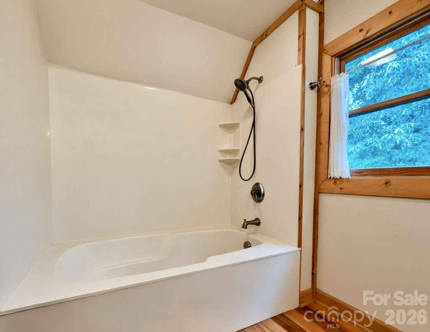 3815 Bat Cave Road Old Fort, NC 28762 - Photo 29 of 45 a bathroom with a bath tub with a shower