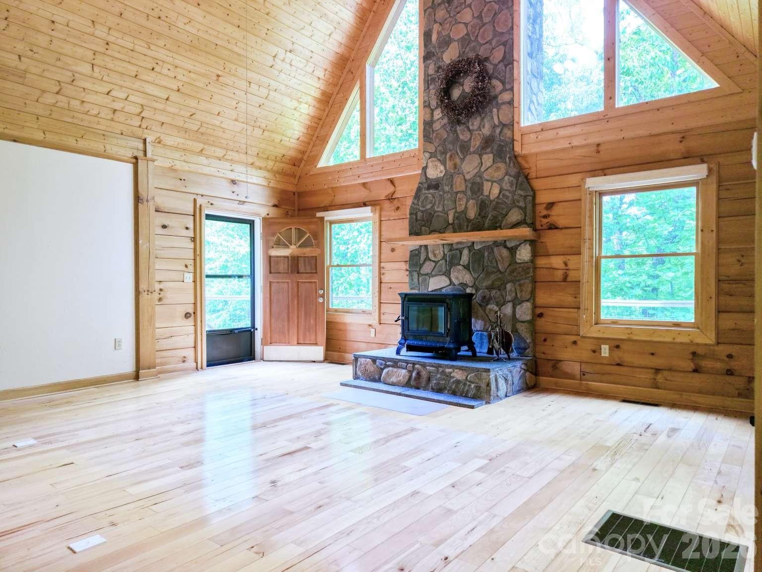 3815 Bat Cave Road Old Fort, NC 28762 - Photo 9 of 45 a view of empty room with wooden floor and a fireplace