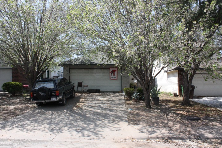 a view of a house with a large tree