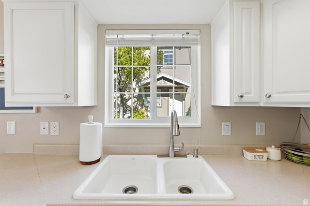 99 Penhurst Place Logan, UT 84341 - Photo 12 of 34 Double basin sink with a chrome faucet, surrounded by solid surface countertops