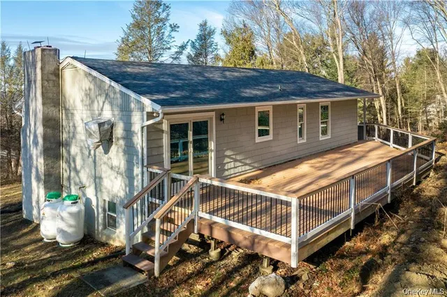 a view of a house with a wooden fence