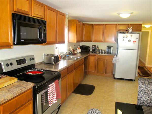 439 Warren Wright Road Belchertown, MA 01007 - Photo 4 of 13 a kitchen with stainless steel appliances granite countertop a stove a sink dishwasher and a refrigerator