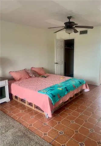 a bedroom with a bed and a mirror