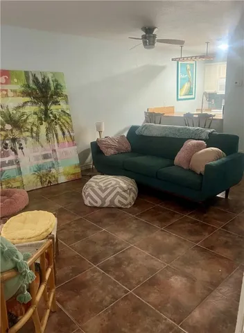 a living room with patio furniture and a fireplace