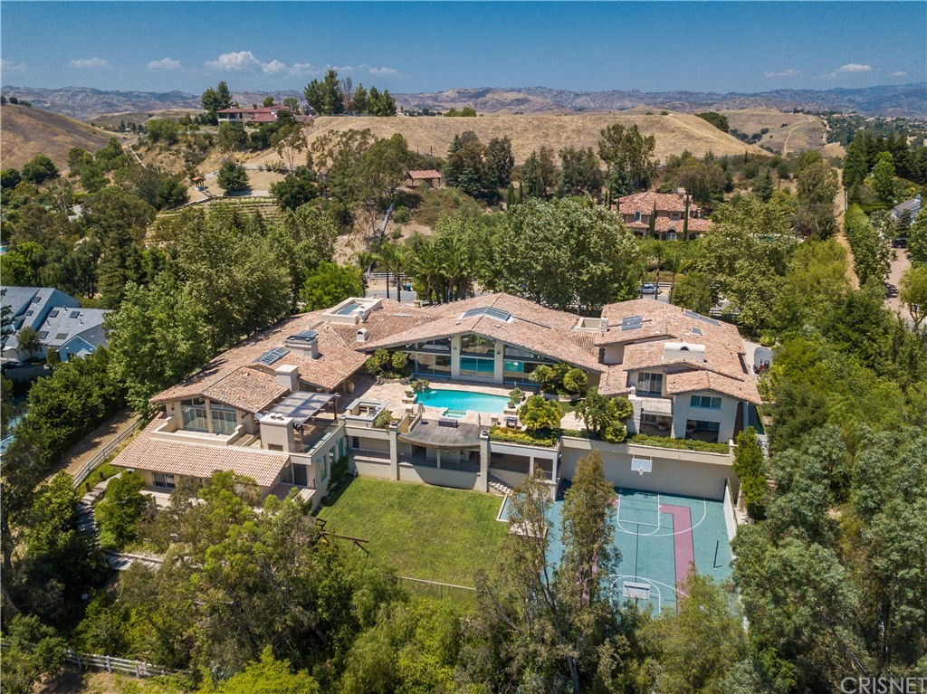 25120 Jim Bridger Road Hidden Hills, CA 91302 - Photo 1 of 1 an aerial view of a house with yard swimming pool and outdoor seating