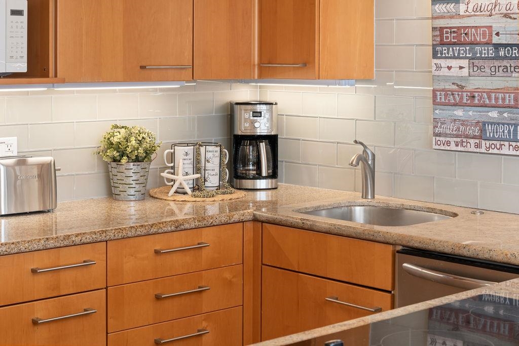 3785 Lower Honoapiilani Road, Unit 208 Lahaina, HI 96761 - Photo 12 of 50 a kitchen with a sink and cabinets