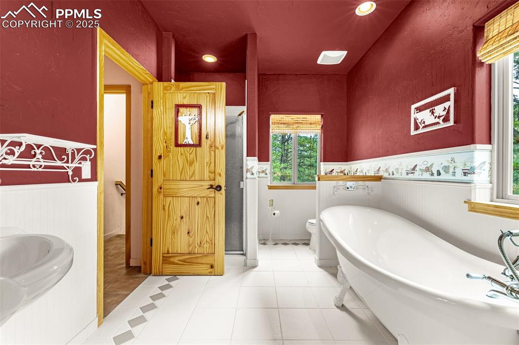 9890 Hardy Road Colorado Springs, CO 80908 - Photo 16 of 41 a bathroom with a sink a toilet and shower