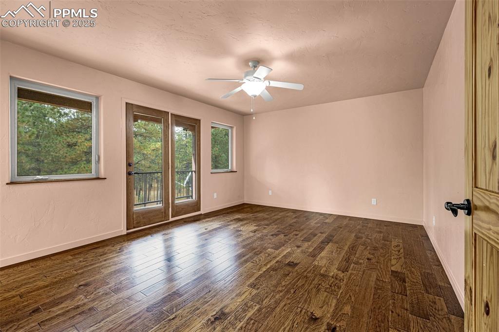 9890 Hardy Road Colorado Springs, CO 80908 - Photo 21 of 41 a view of an empty room with wooden floor and a window