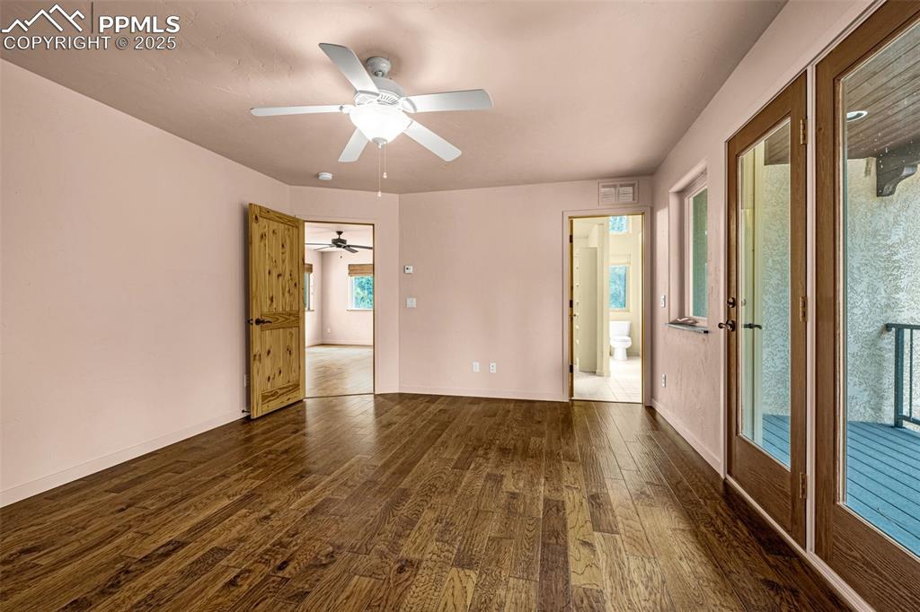 9890 Hardy Road Colorado Springs, CO 80908 - Photo 22 of 41 a view of an empty room with wooden floor and a window