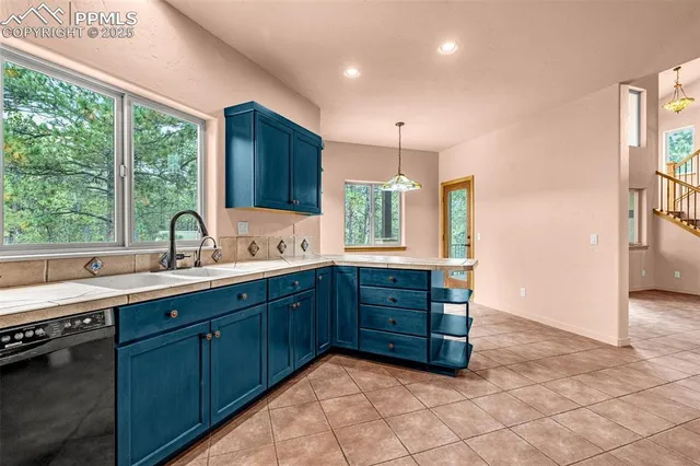 a kitchen with stainless steel appliances granite countertop a sink and a large window