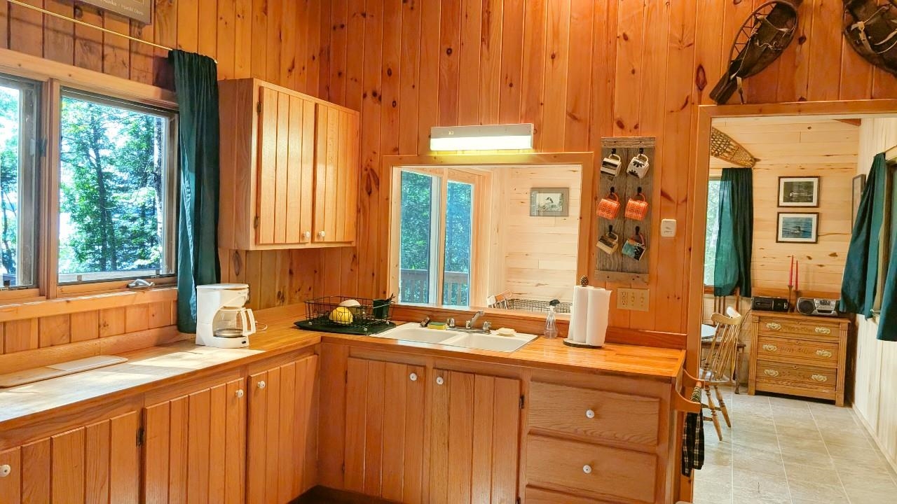 8884 Raps Road Cook, MN 55723 - Photo 15 of 46 Kitchen featuring wooden walls and tile countertops