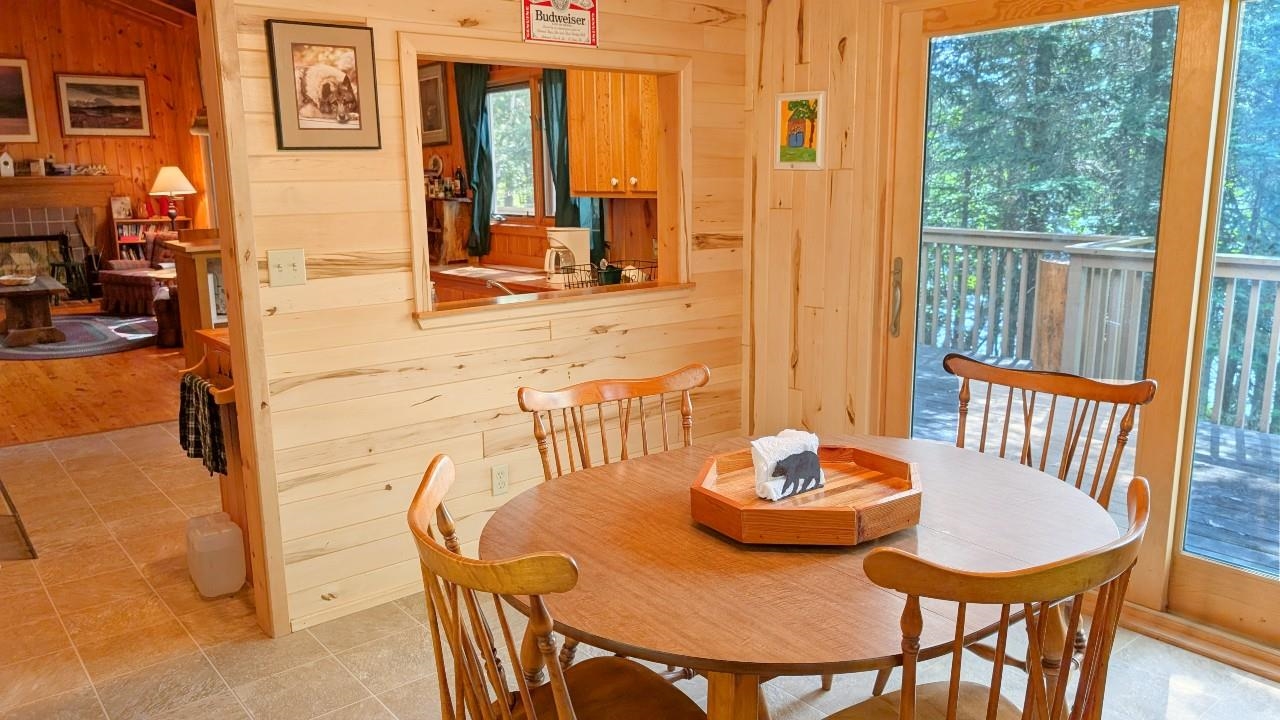 8884 Raps Road Cook, MN 55723 - Photo 16 of 46 Tiled dining area with wooden walls