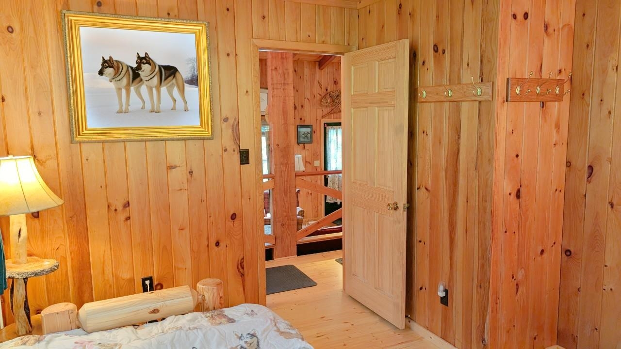 8884 Raps Road Cook, MN 55723 - Photo 18 of 46 Bedroom featuring wooden walls and wood finished floors