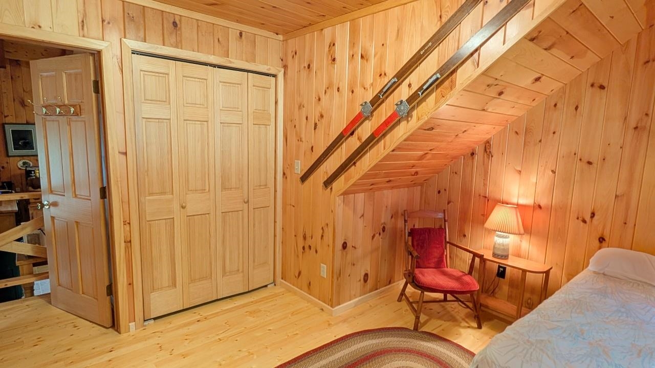 8884 Raps Road Cook, MN 55723 - Photo 20 of 46 Bedroom with wood ceiling, wood walls, wood finished floors, and a closet