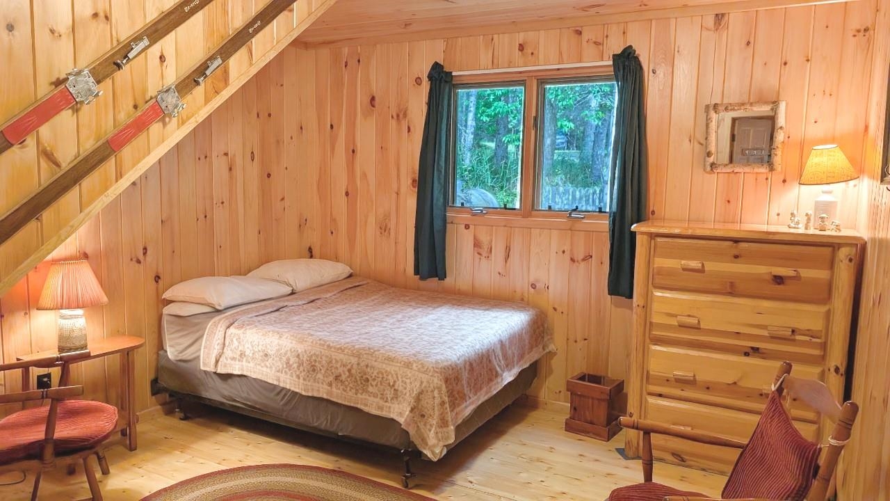 8884 Raps Road Cook, MN 55723 - Photo 22 of 46 Bedroom featuring wood finished floors and wooden walls