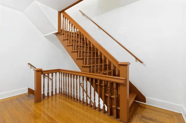 a kitchen with granite countertop wooden floors and stainless steel appliances