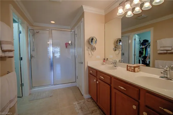 a spacious bathroom with a shower sink double and mirror