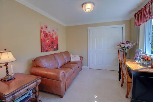 a living room with furniture and a lamp