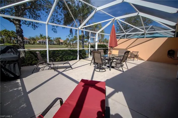 a view of a patio with a table and chairs