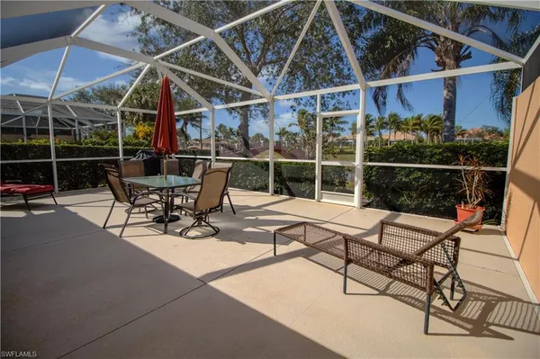 a view of a roof deck with chair and table