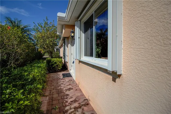 a view of a entryway door with potted plants in front of door