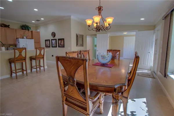 a view of a dining room with furniture and chandelier