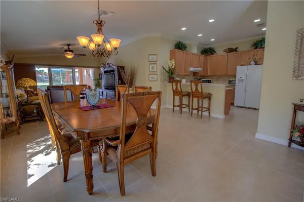 a view of a dining room with furniture and chandelier