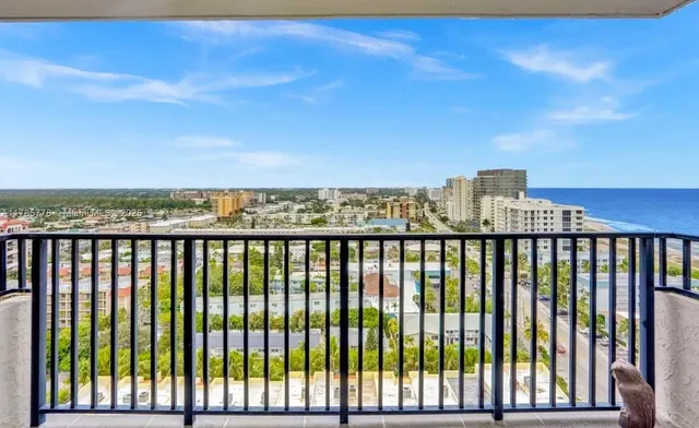 a living room filled with furniture and floor to ceiling window