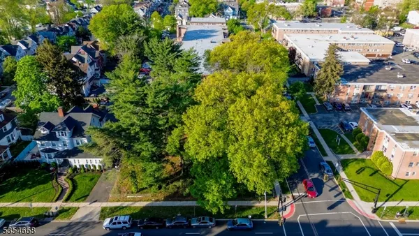 an aerial view of residential houses and car parked on street side