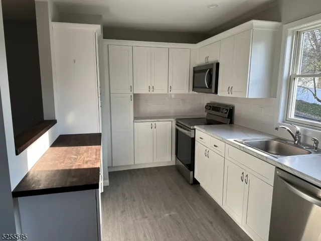 a kitchen with a sink stove and microwave