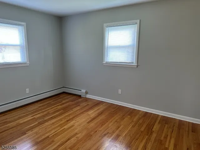 a view of a room with wooden floor and window