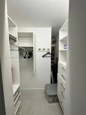 a view of a kitchen with kitchen island and stainless steel appliances