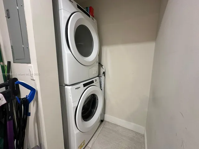 a living room with furniture a flat screen tv and a window