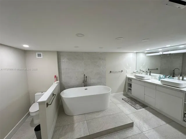 a view of a hallway to rooms and stairs