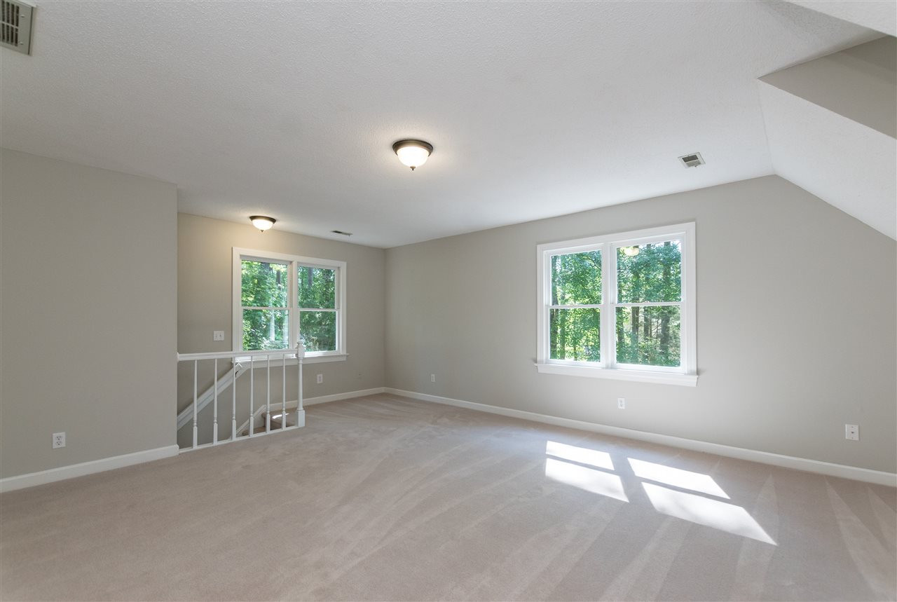 4908 Fielding Drive Raleigh, NC 27606 - Photo 21 of 25 This bonus room is huge! It would make an excellent playroom, a wonderful man cave, or use it as a fifth bedroom. There are backstairs that go to a hallway that accesses the backyard, garage, or kitchen. Bonus Room