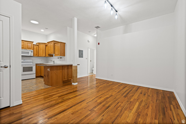 70 North Main Street, Unit 213 Bountiful, UT 84010 - Photo 1 of 15 Open-concept living area featuring wood-finish flooring, white walls, and track lighting