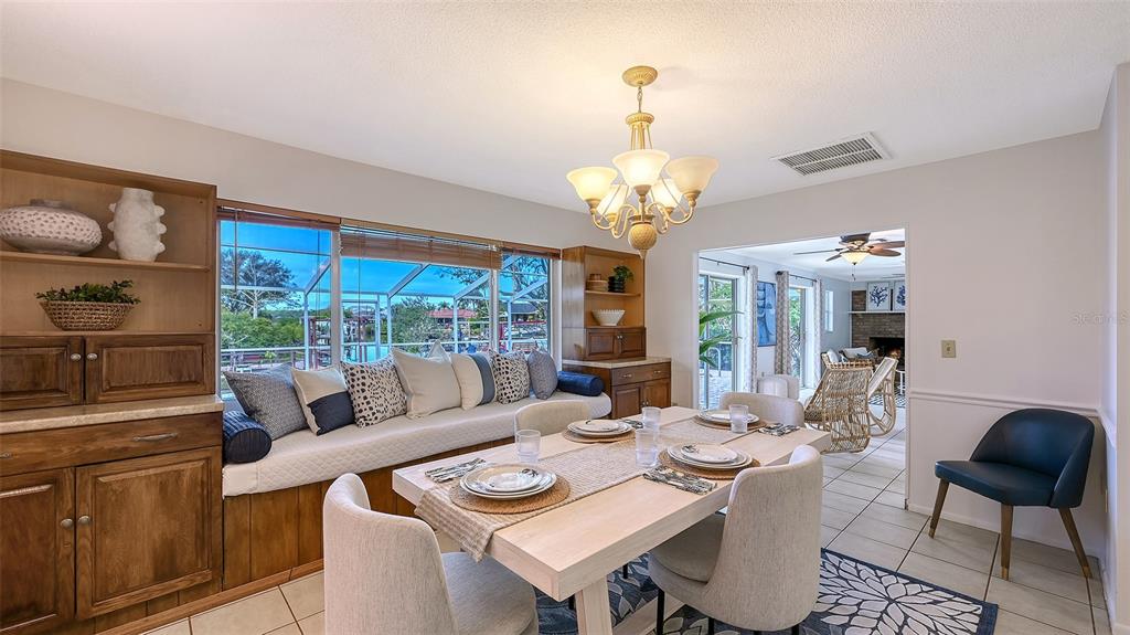 619 Albee Farm Road North Nokomis, FL 34275 - Photo 19 of 93 a view of a dining room with furniture wooden floor and chandelier