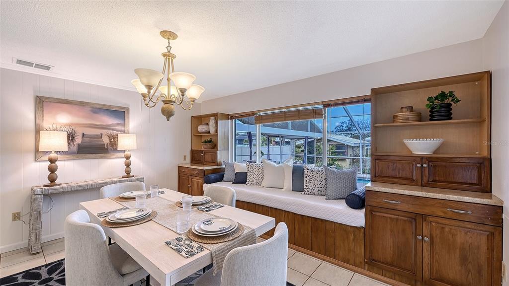 619 Albee Farm Road North Nokomis, FL 34275 - Photo 20 of 93 a view of a dining room with furniture a chandelier and wooden floor